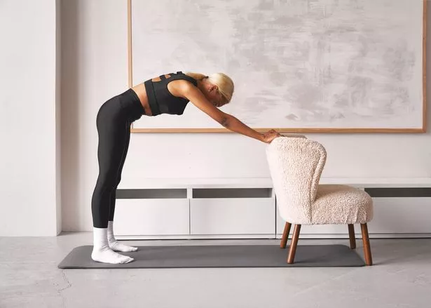 The fourth exercise is the roll-down with a chair