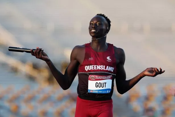 Gout Gout holds the relay baton on the track