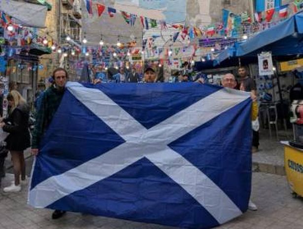 Missing Robert holding a Scotland flag