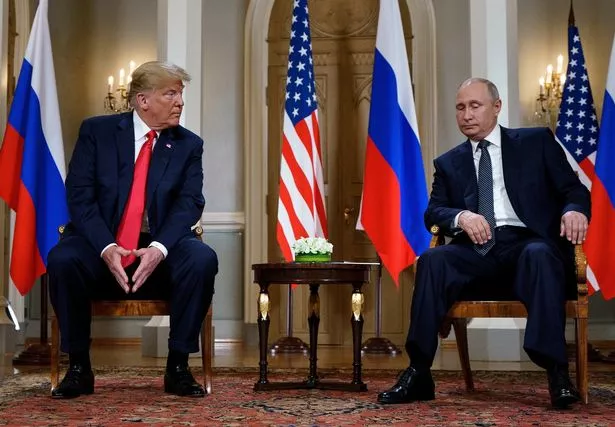 (FILES) Russian President Vladimir Putin (R) and US President Donald Trump are pictured before a meeting in Helsinki, on July 16, 2018. US President Donald Trump stepped up the pressure on Russian counterpart Vladimir Putin to make a peace deal with Ukraine, threatening tougher economic measures if Moscow does not agree to end the war. Trump's warning in a Truth Social post on January 22, 2025, came as the Republican seeks a quick solution to a grinding conflict that he had promised to end before even starting his second term. (Photo by Brendan Smialowski / AFP) (Photo by BRENDAN SMIALOWSKI/AFP via Getty Images)