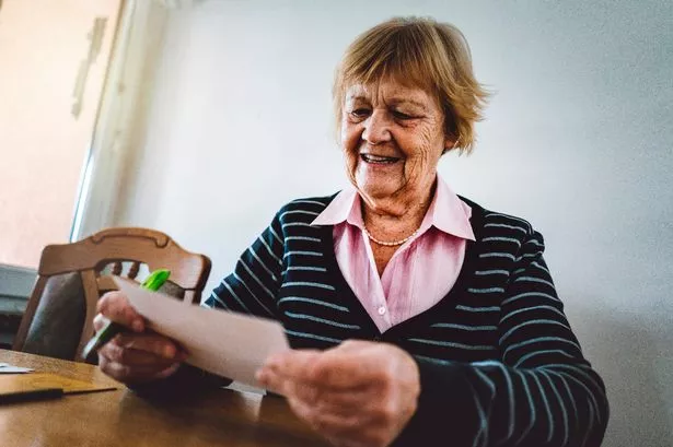 Older woman reading letter