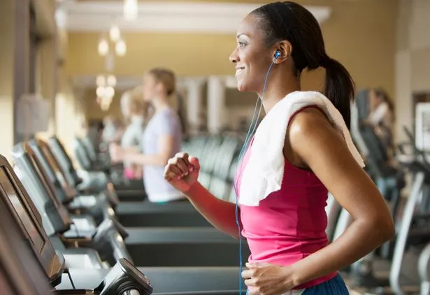 Woman exercising on treadmill in gym