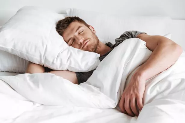 Man sleeping in bed at home