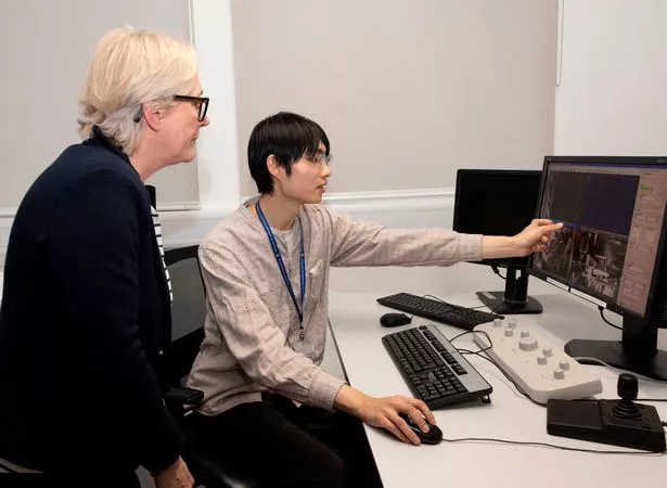 Student shows woman data on screen