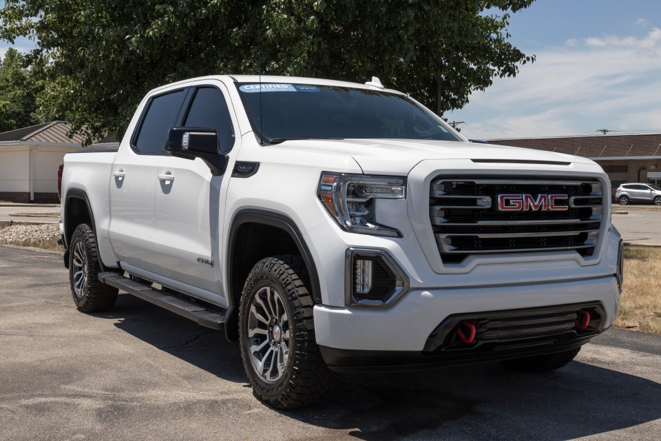 White GMC Sierra 1500 AT4 pickup truck.