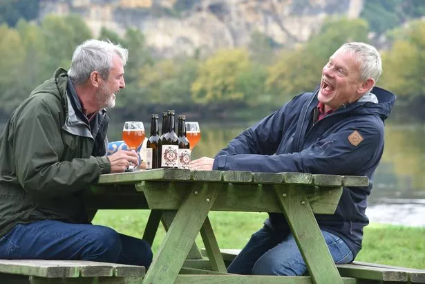 Neil Morrissey and Martin Clunes enjoy a pint on a picnic bench in their new show Neil and Martin's Bon Voyage