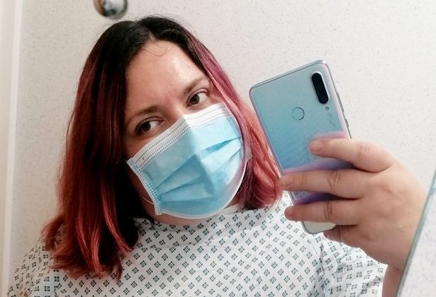 Ashleigh wearing a hospital mask and gown