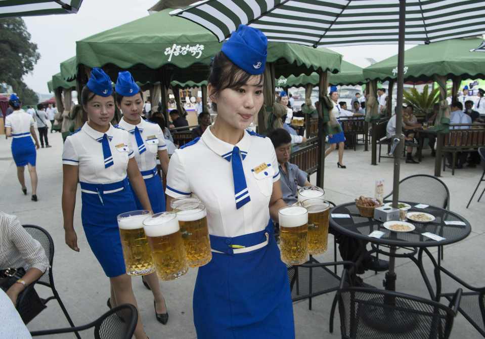 Waitresses carrying beer at a beer festival.