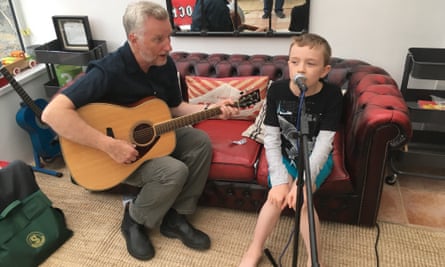 James with a micophone playing with Billy Bragg who is on a guitar, 2016.