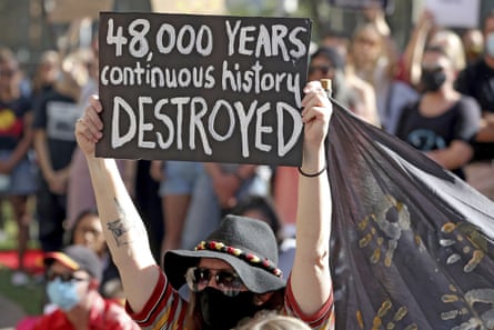 A protester holds a placard outside Rio Tinto’s offices in Perth, Australia in June 2020.