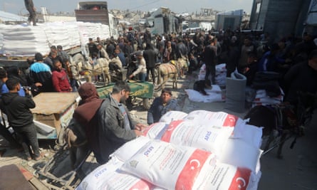 People receiving bags of flour at an Unrwa distribution centre earlier in March.