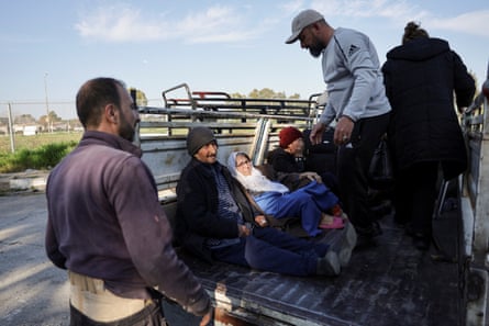 A Syrian Alawite family rides in a truck 