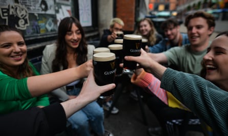 People drinking Guinness in Dublin.