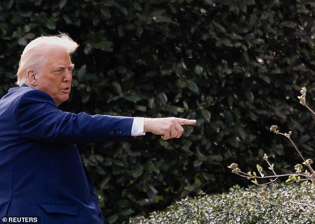 Trump points a finger as he returns to the White House after attending a board meeting at the Kennedy Center