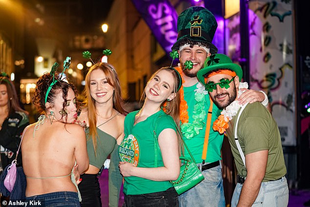 St Patrick's Day drinkers seen dressed in green tops, tall hats and themed glasses and headbands in Nottingham