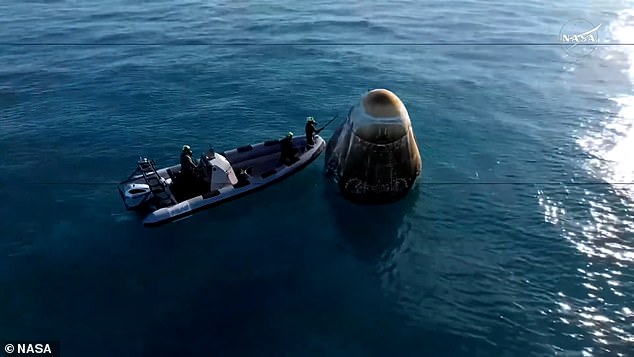 A recovery team worked to retrieve the Dragon capsule and load it onto a recovery vessel