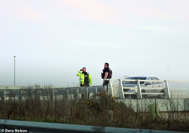 The vehicle was being driven on the M55 near to junction 2. Pictured: police searching on the M55