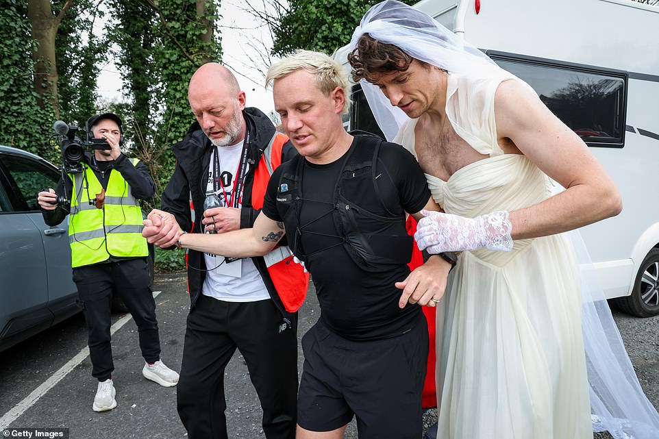 He was propped up as he arrived at another pit stop on his final leg of the challenge