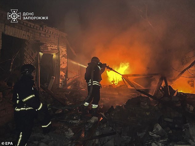 Ukrainian rescuers working at the site of a drone attack in Zaporizhzhia, Ukraine, late 21 March 2025