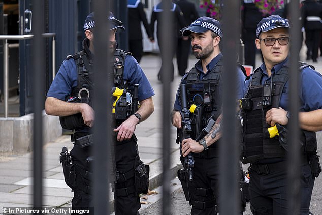 Armed officers stand by the gates of Downing Street, which has 'gradually become a sort of fortress, largely in response to terror threats'