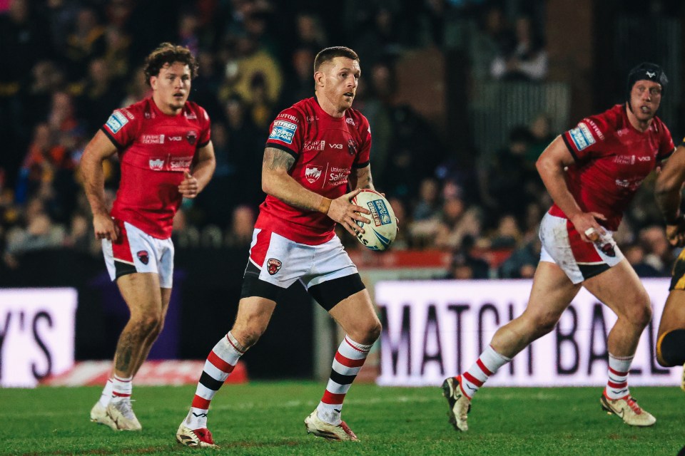 Marc Sneyd of Salford Red Devils rugby team with the ball during a match.