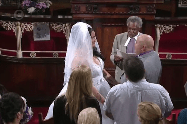 A bride and groom getting married in a church ceremony.