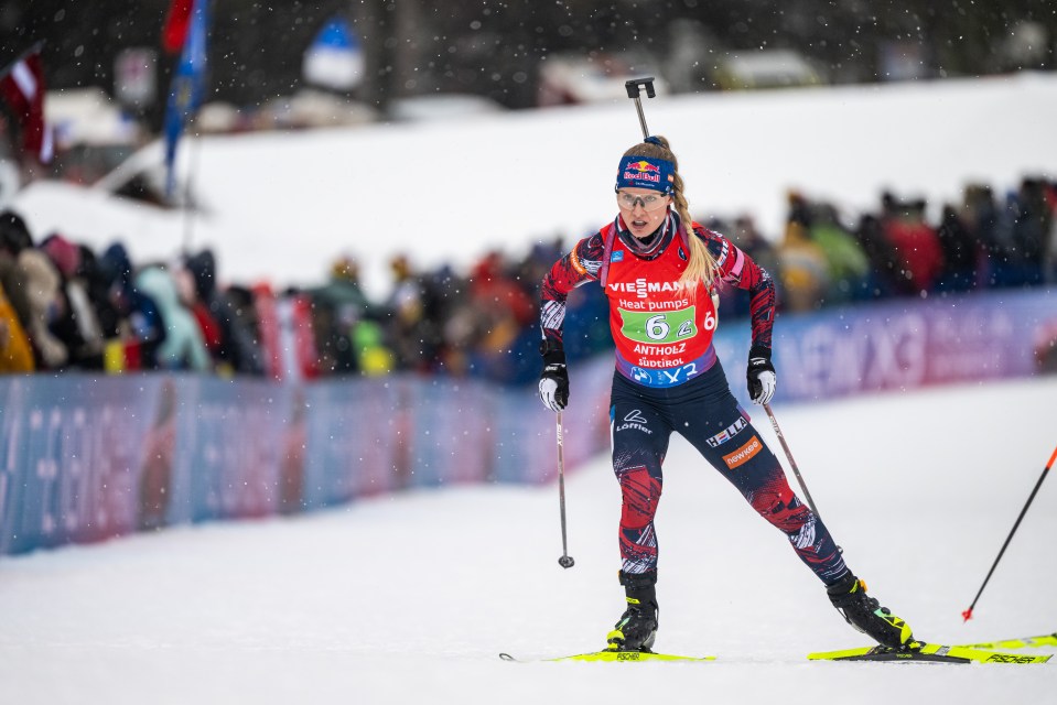 Anna Gandler of Austria competing in a biathlon race.