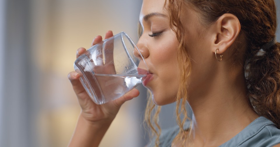 Woman drinking water.