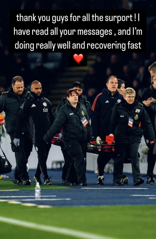 Medical personnel carrying an injured player off the field.