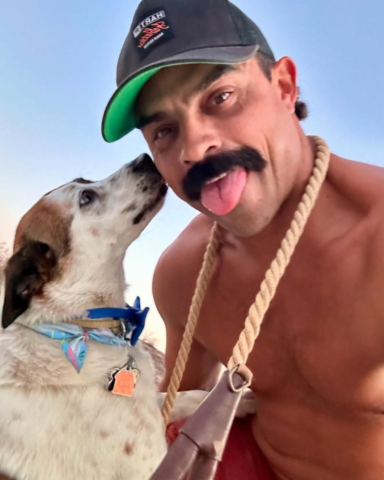 A man with a mustache and a dog.