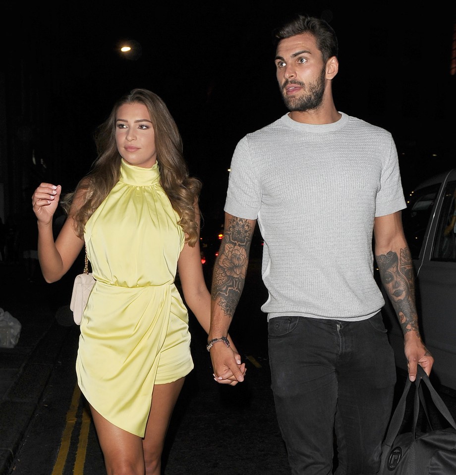 Zara McDermott and Adam Collard holding hands.