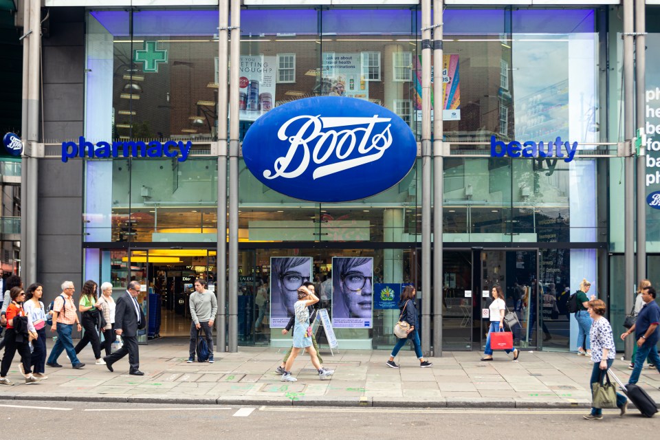 People walking past a Boots pharmacy in London.