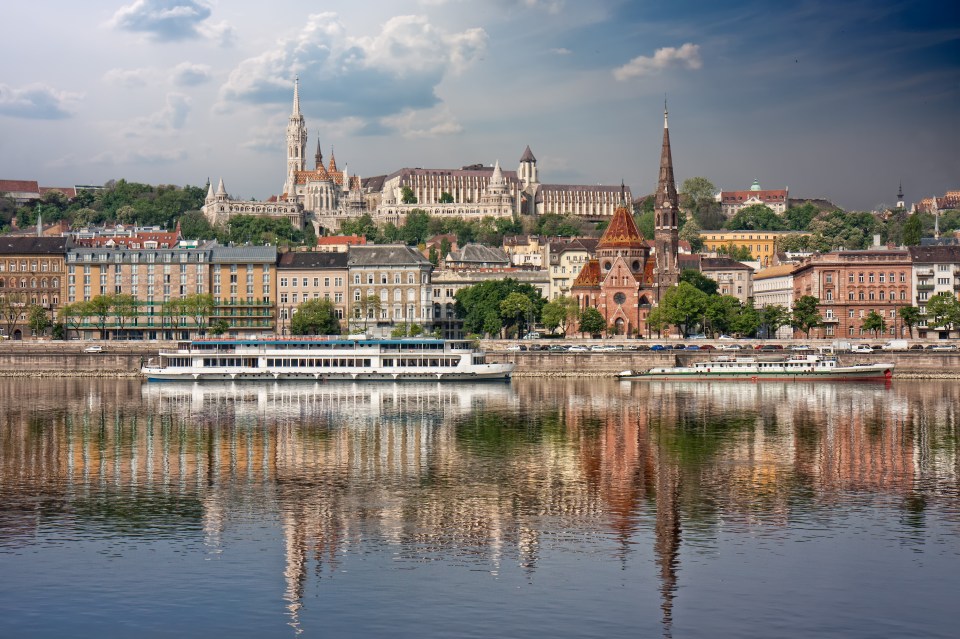 Budapest cityscape reflected in the Danube River.