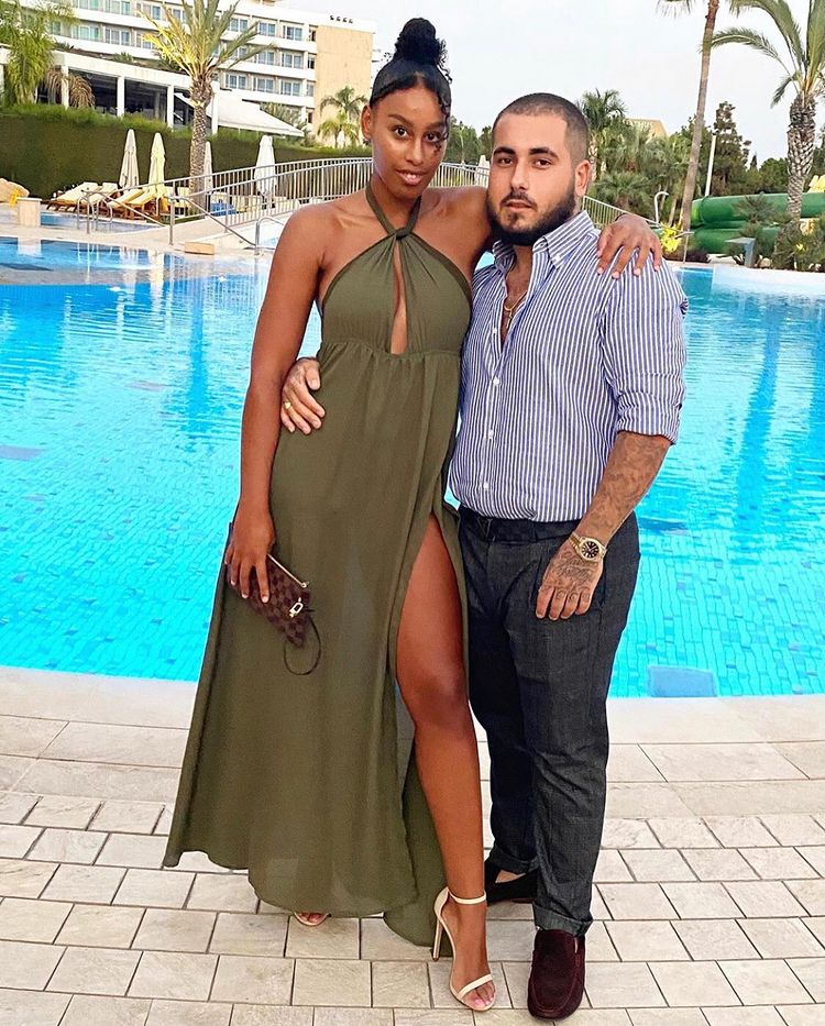 Couple posing by a pool.