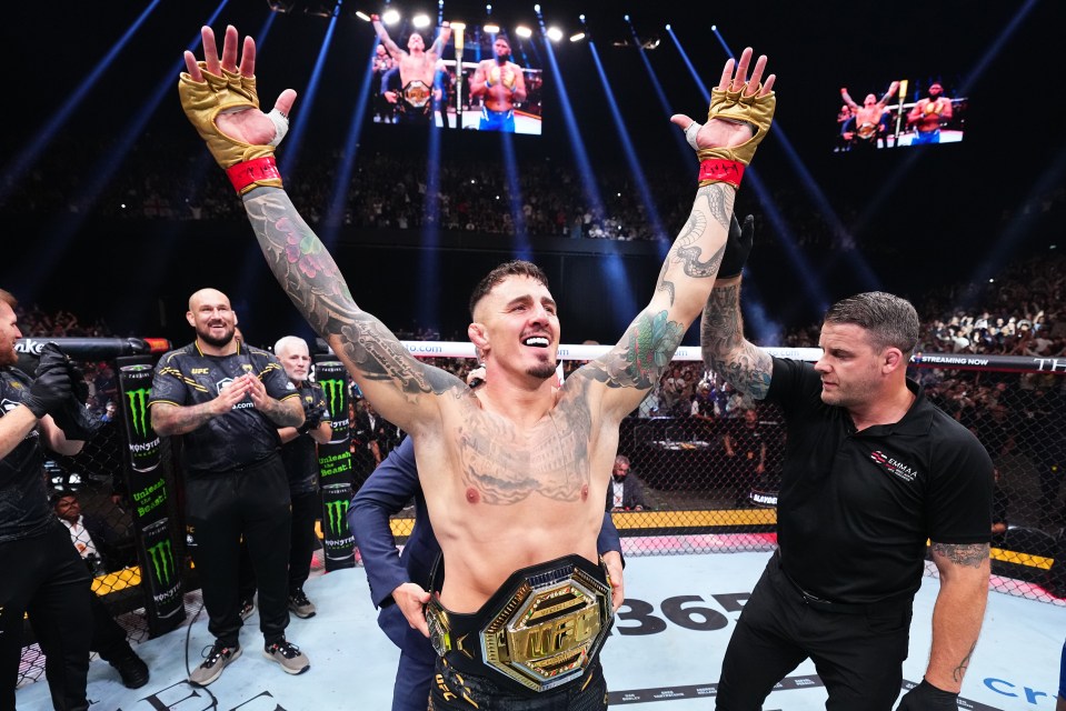 Tom Aspinall of England celebrates his UFC heavyweight championship victory.