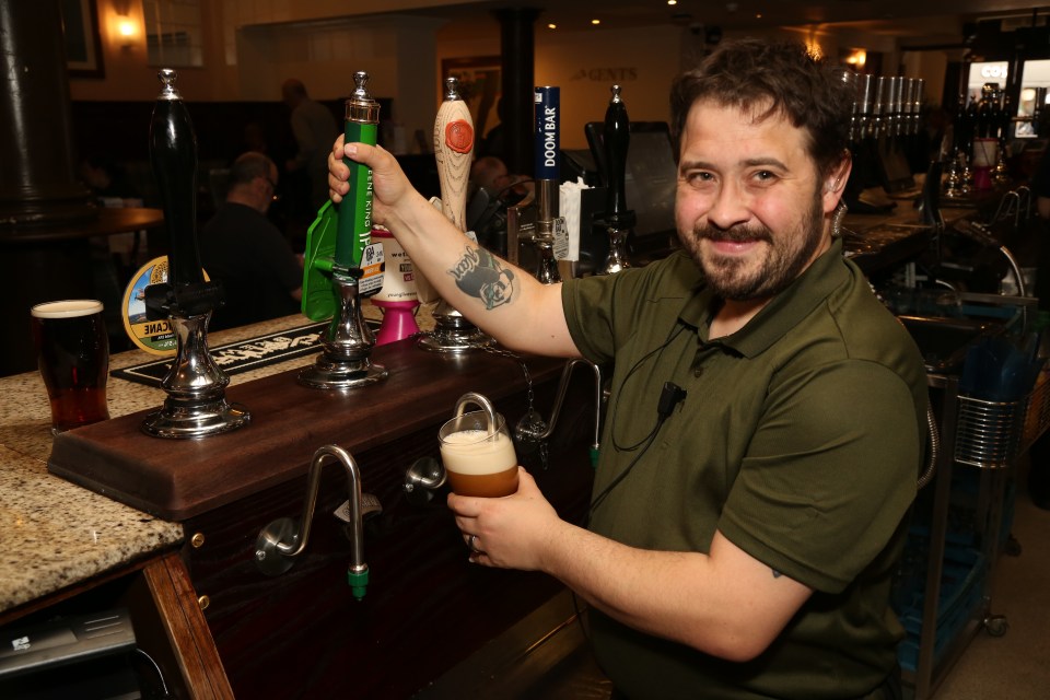 Bartender pouring beer at a pub.