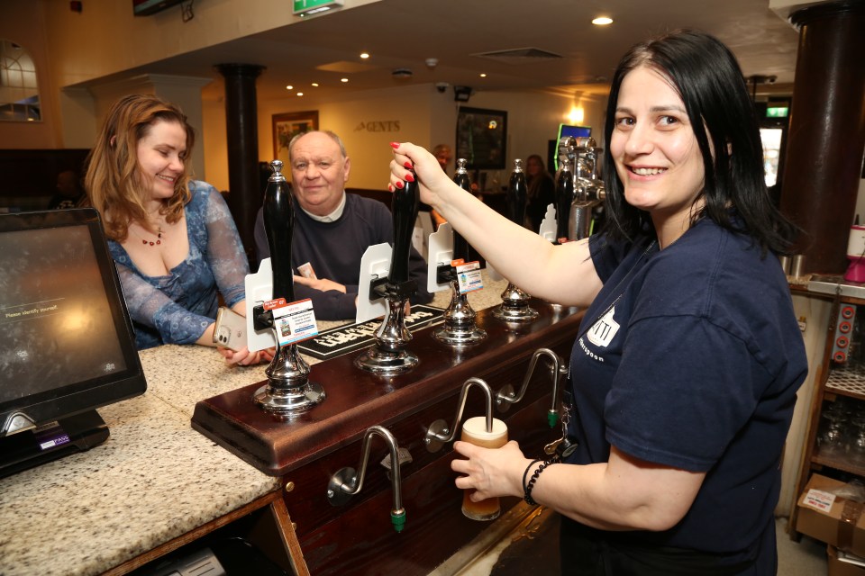 Bartender pouring a pint of beer.