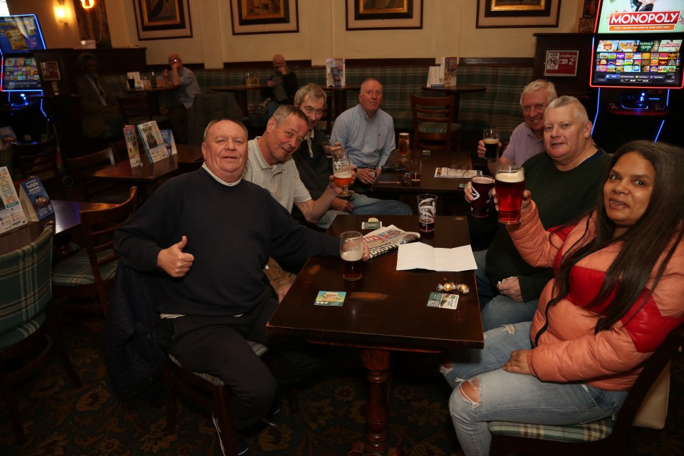 Patrons enjoying drinks at a pub.