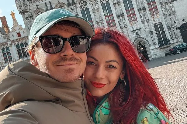 Joe Sugg and Dianne Buswell wrapped up whilst taking a selfie in a square in Belgium.