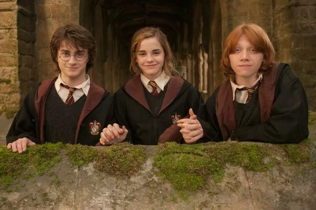Actors, Daniel Radcliffe, (L) Emma Watson (M) and Rupert Grant (R) on the set of the film, 'Harry Potter and The Goblet of Fire', London, England, 2005 (Photo by Murray Close/ Getty Images)