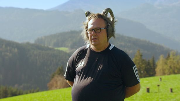 Destination X's Daren with headphones on whilst on a hill.