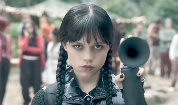 A girl with dark hair holds a fog horn