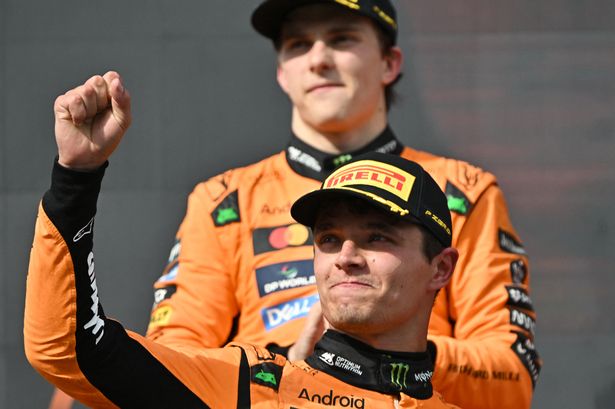 Lando Norris celebrates winning the Hungarian Grand Prix in front of McLaren team-mate and F1 title rival Oscar Piastri