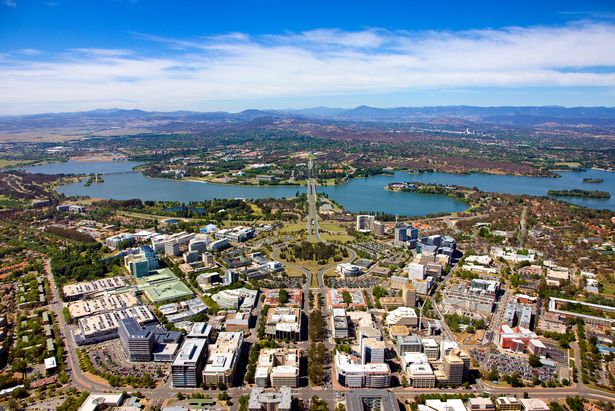 Aerial view of Canberra, Australia showing houses and body of water