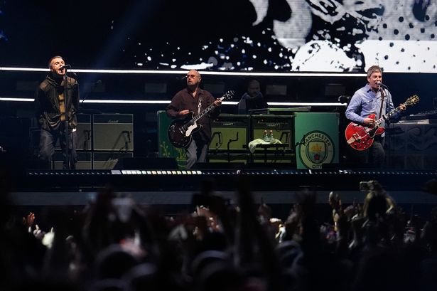 Oasis on stage at a gig in Cardiff last month.