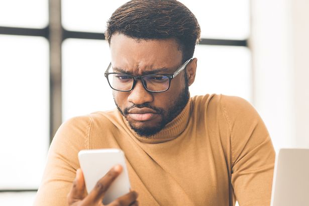 A man checks his phone