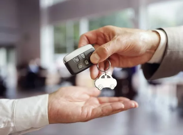 Car sales buying a new car handing over the keys