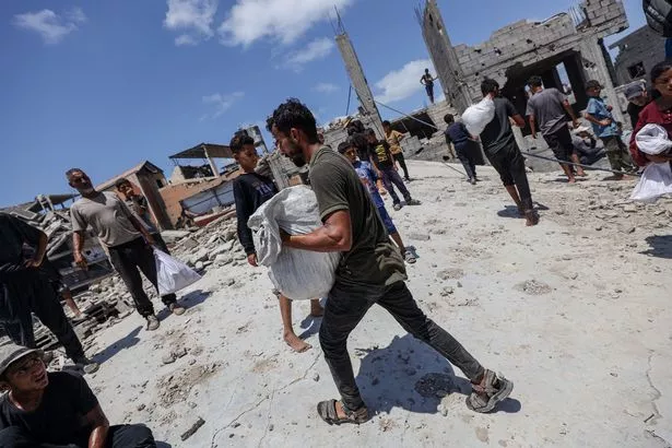Desperate locals search for aid drop