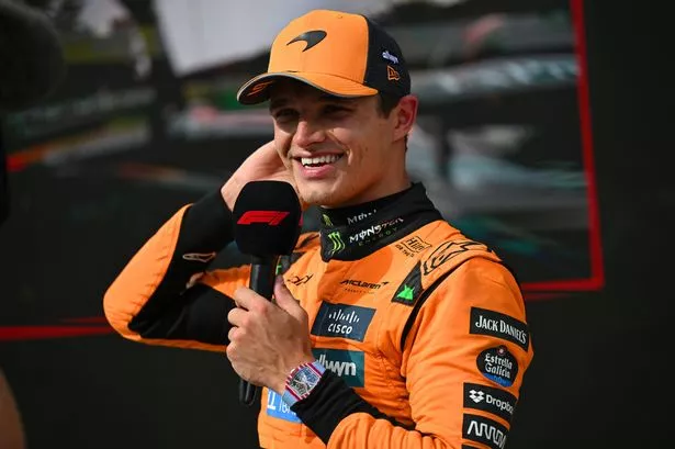 Lando Norris speaks into an F1-branded microphone after winning the Hungarian Grand Prix