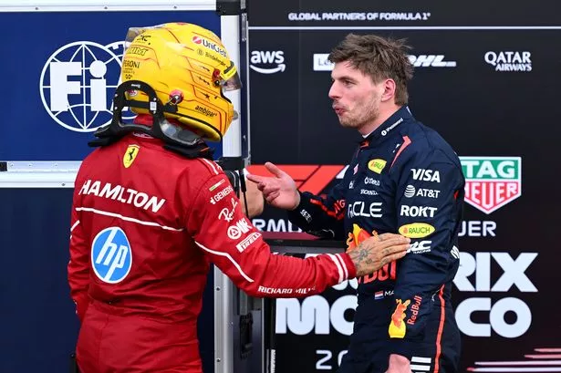 Max Verstappen and Lewis Hamilton speak in parc ferme